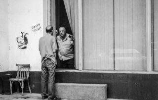 Man speaking with police officer through window