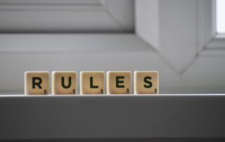 Similar cubes with rules inscription on windowsill in building