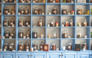 Assorted jars on blue shelf cabinets