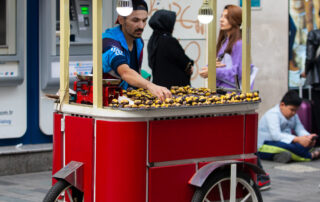 Ethnic man selling food on city street