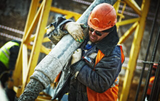 Man carrying gray pipe