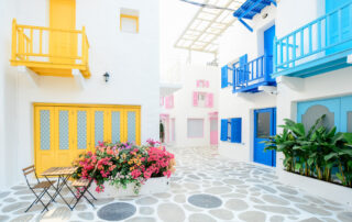 Architectural photography of three pink blue and yellow buildings